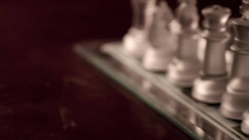 Glass Chess Pieces on a Game Board
