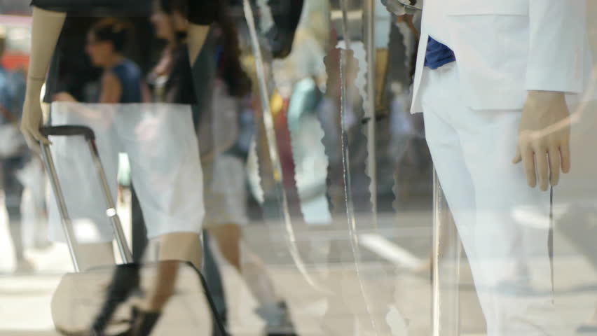 Shop display dummys, signage, reflections and blurred background make an impressionistic image of window shopping.