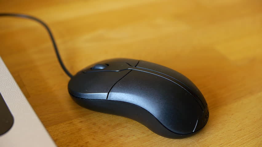 Camera tracks over a mouse and the keyboard of a laptop.