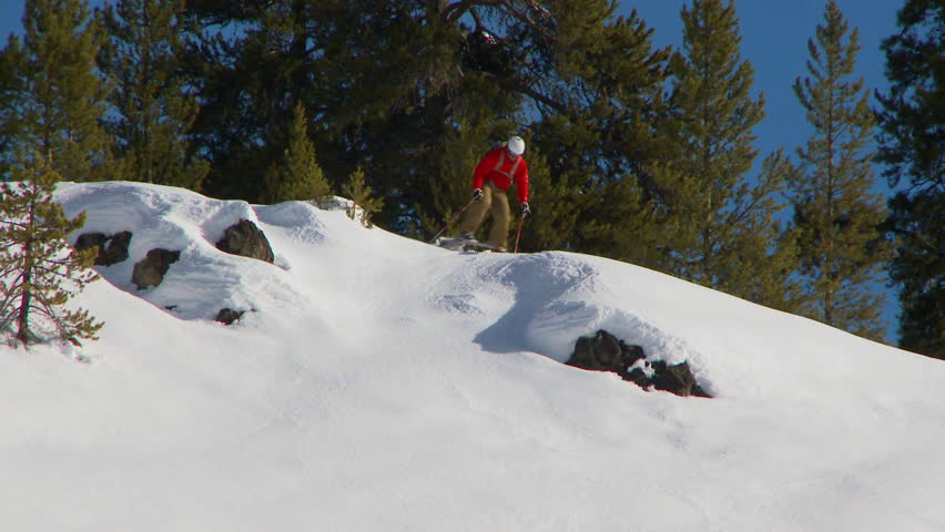 Male skier carving through back-country powder