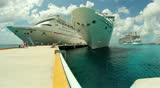 COZUMEL, MEXICO - July, 2012 Tourists walk past the cruise ships Carnival Elation, Carnival Paradise, and Royal Caribbean's Oasis of the Seas docked at Cozumel, Mexico. 