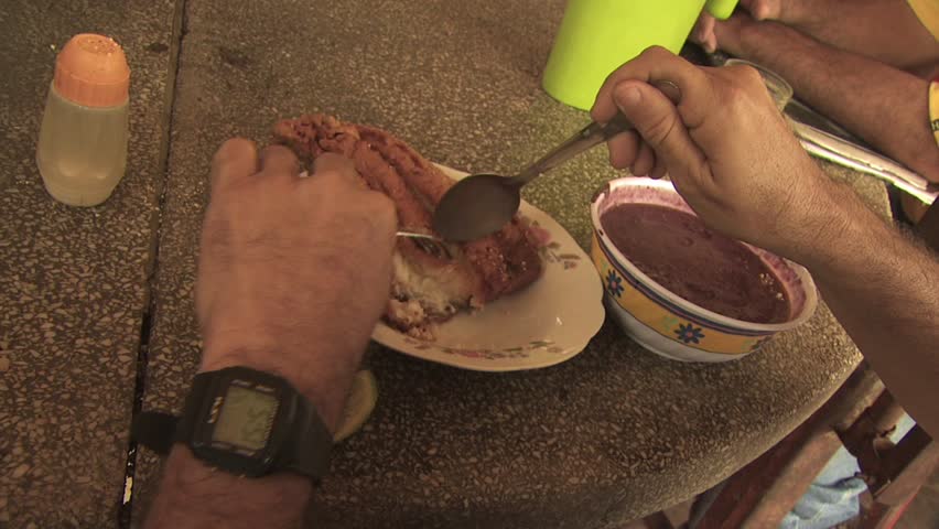 AMAZON REGION, BRAZIL - CIRCA 2010:  People eating local indigenous food made from acai berries