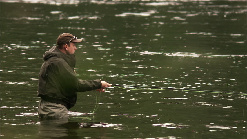 A man fly-fishing in a river