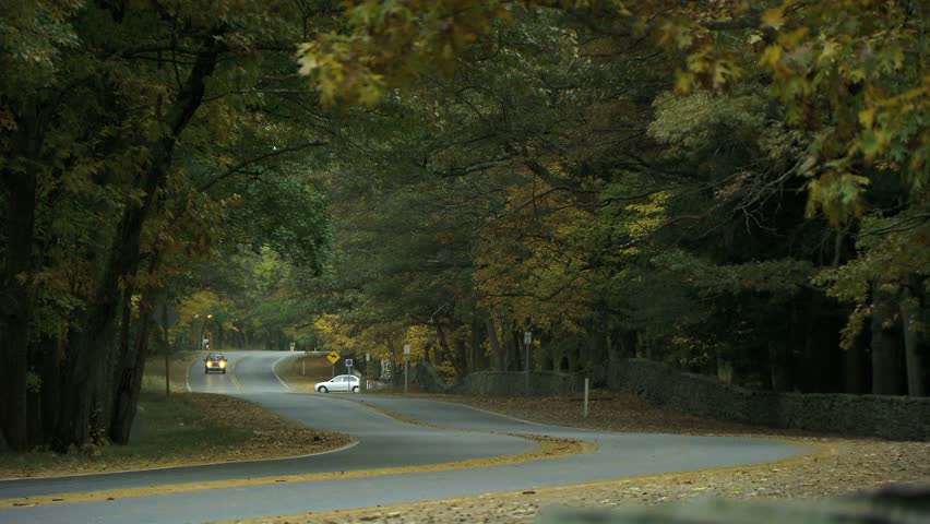 NEW ENGLAND - CIRCA NOVEMBER 2009: United States Postal Service delivery truck passing camera on country road