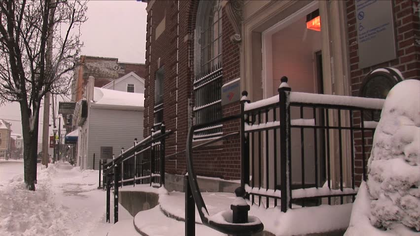NEW ENGLAND - CIRCA JANUARY 2006: Small downtown retail storefronts and street in snow
