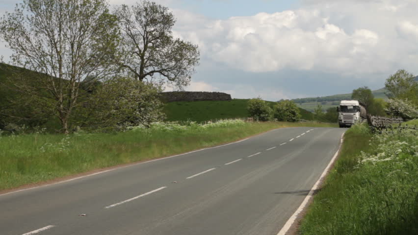 WHARFEDALE, YORKSHIRE/ENGLAND - JUNE 4: A lorry shatters the peace and quiet of the countryside on June 4, 2012 in Wharfedale. The Yorkshire Dales National Park is famous for its scenic tranquility.