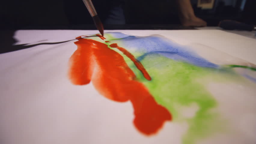 Woman artist painting watercolor paints