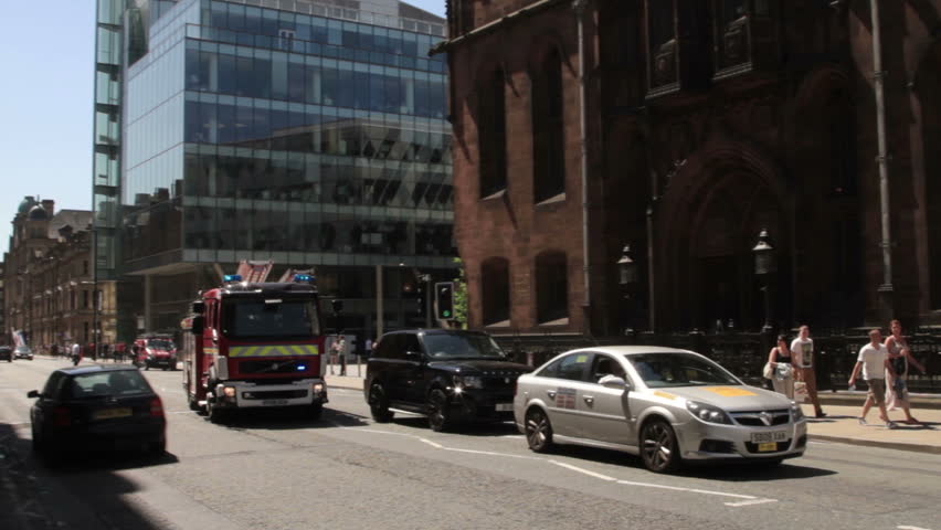 MANCHESTER, LANCASHIRE/ENGLAND - MAY 25: Fire engine rushes down  Deansgate Street with siren sounding on May 25, 2012 in Manchester. Deansgate Street is one of Manchester's oldest thoroughfares.
