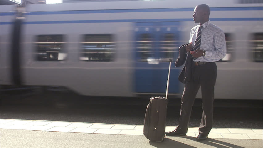 A businessman at a train station