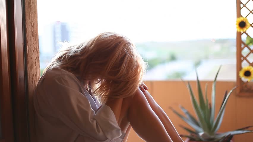 Woman desperate on terrace at home