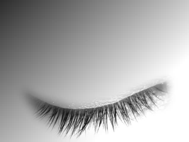 Brown eye opens. Grey soft background.
