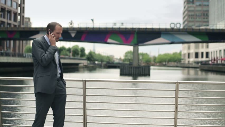 Young handsome businessman talking on mobile phone in the city
