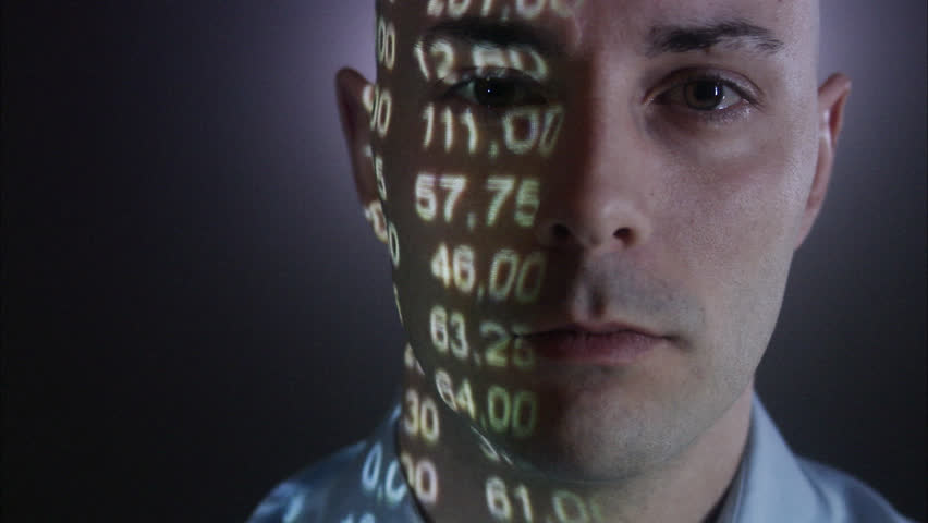 A man with the stock-exchange quotation reflected on his face.