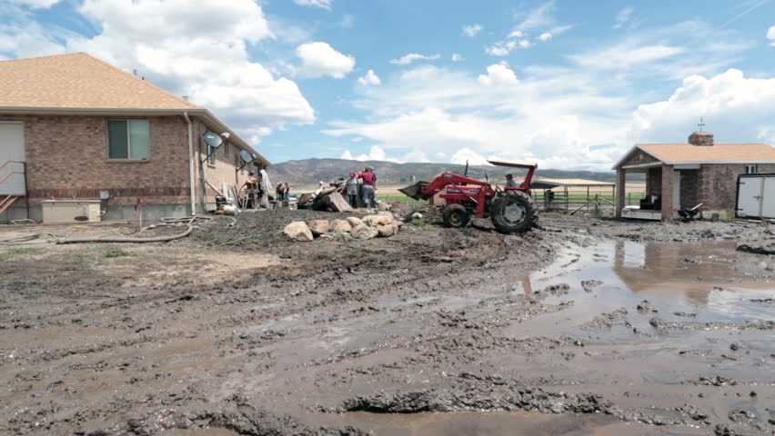 FOUNTAIN GREEN, UTAH 30 JUL 2012: Home house flooded with water and mud from flash flood. Friends and volunteer help haul property away destruction. Destructive nature force. Church service.