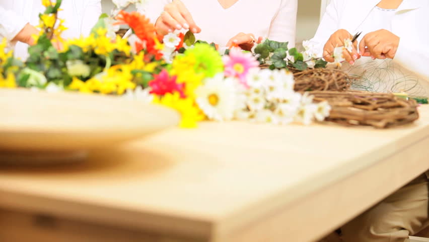 Senior ladies having fun leisure time together flower arranging