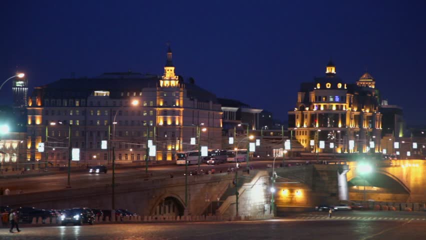 Night traffic on street and quay at evening in Moscow