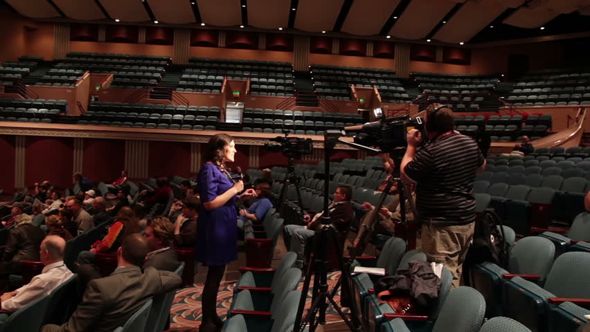 TOPEKA, KS - MARCH 9: Reporter from a local TV station broadcasting during a visit from Ron Paul on March 9, 2012 in Topeka, KS.