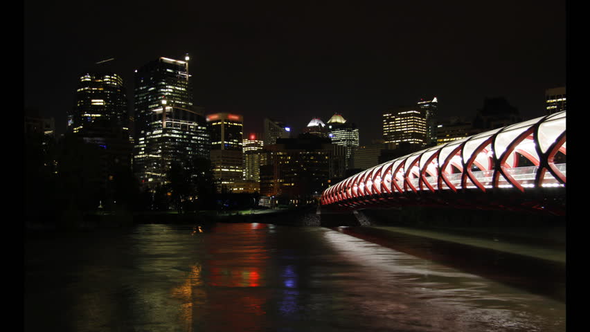 This is a night time lapse scenic featuring downtown Calgary, Peace Bridge, and the Bow River