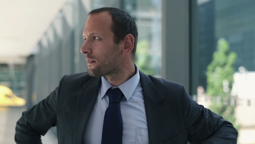 Portrait of successful happy businessman with crossed hands
