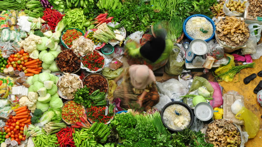 MALAYSIA - JANUARY 24: Time lapse of Muslim woman selling fresh vegetables at the traditional bazaar market Siti Khadijah Kota Bahru on January 24, 2011 in Kelantan, Malaysia. 
