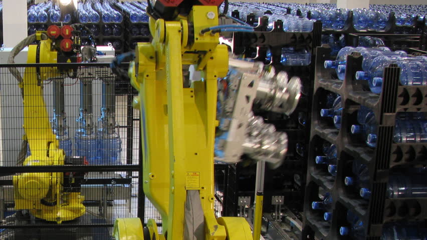 Bottled water factory. Big robotic hands. Production line. Time lapse, loopable.