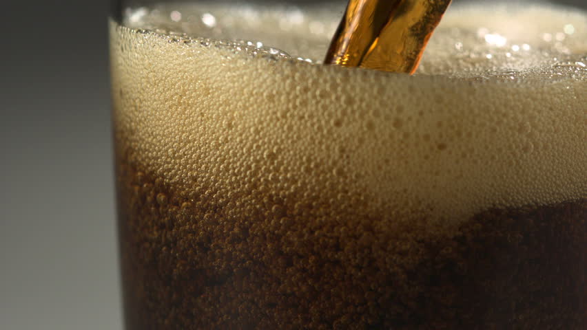 Pouring soft drink into glass shooting with high speed camera.