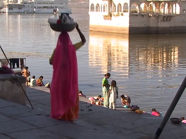 Indian woman is going to the lake for laundry