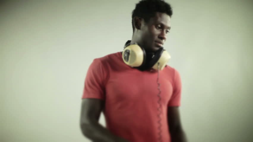 young african guy waving and dancing with a cool attitude on a red t-shirt
