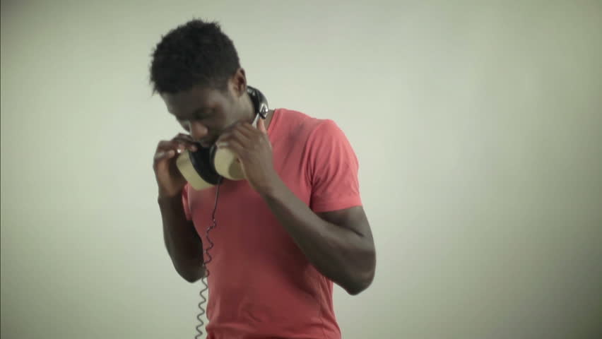 young african guy waving and dancing with a cool attitude with a red t-shirt