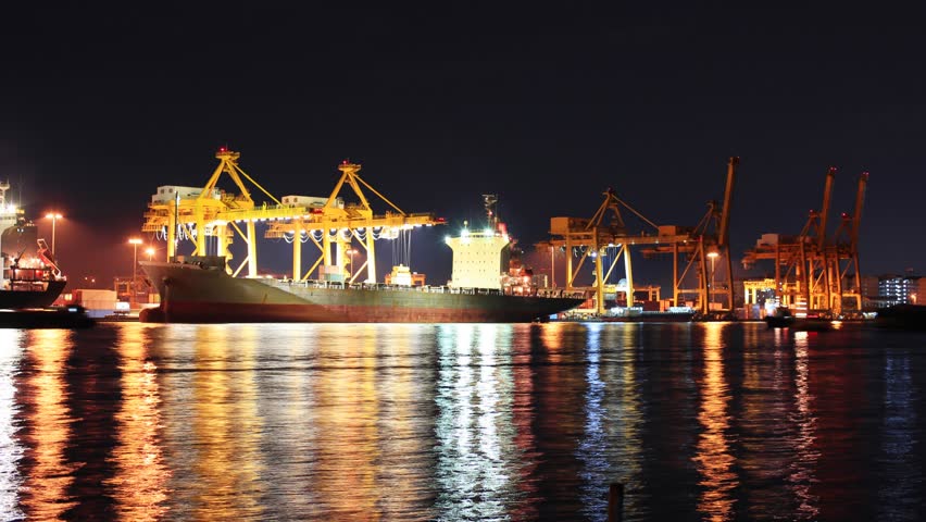 Container Cargo freight ship with working crane bridge in shipyard at dusk for Logistic Import Export background