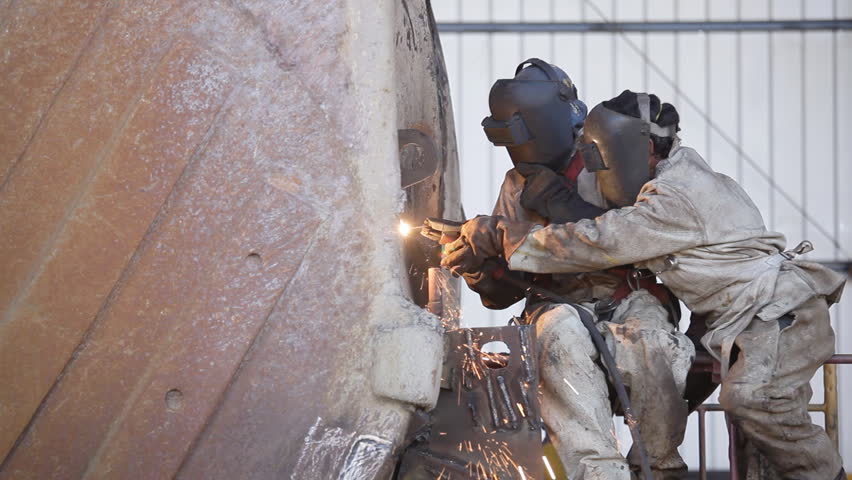 Welders repairing heavy equipment for the mining industry