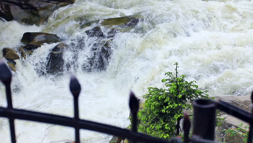 forged railings, fir on stone and waterfall, focusing at background
