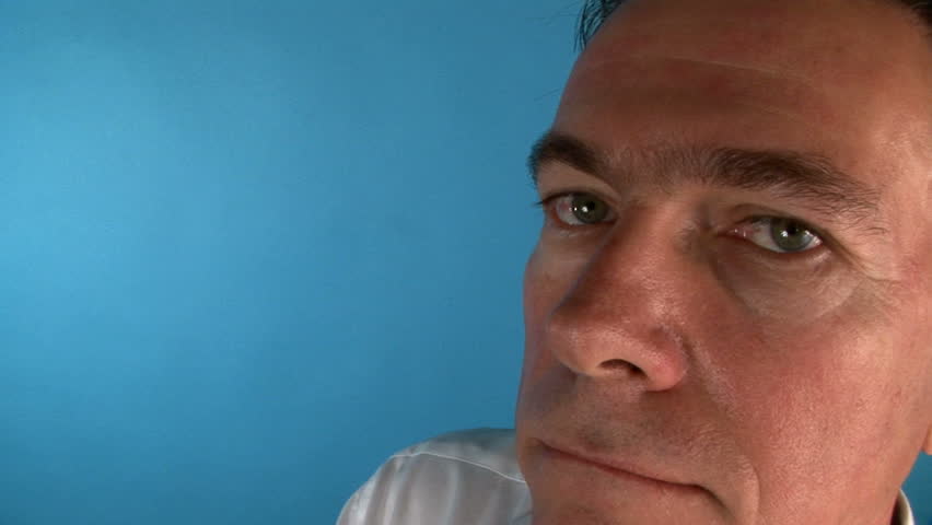 Fisheye view of a man who may be a banker or debt collector holding a past due mortgage notice.