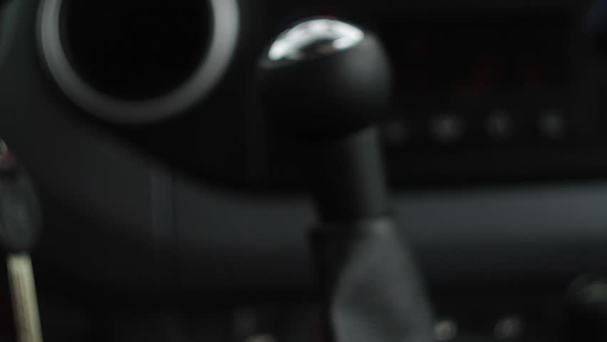 Close up of hand on manual gear shift knob