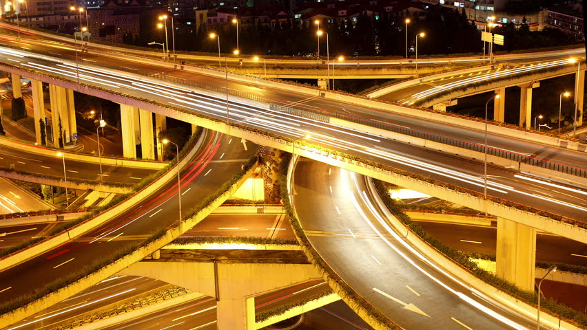 Freeway interchange, heavy traffic at night.