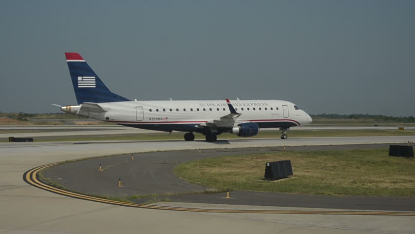 CHARLOTTE - AUGUST 2: US Airways Embraer 175 jet airplane arrives in Charlotte, NC on August 2, 2012. US Air has entered talks to merge with American Airlines.