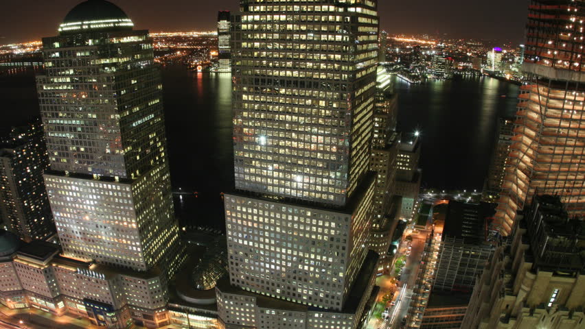 Time lapse of lower Manhattan buildings along the Hudson River with both street and river traffic.