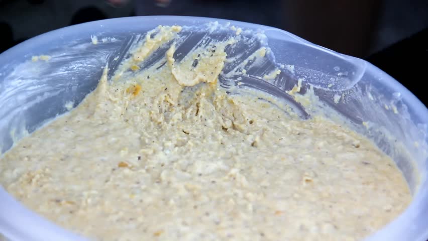 Small Scoop Being Used To Scoop Batter In A Bowl