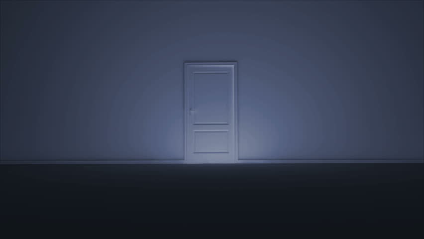 A man walking in a dark room with a strong light coming from behind