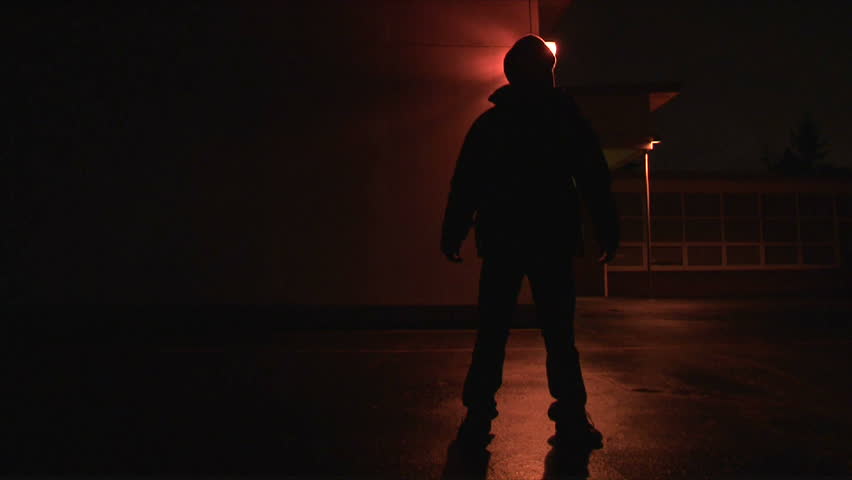 Person disappears and reappears exterior, night, then walks towards camera blacking out lens.