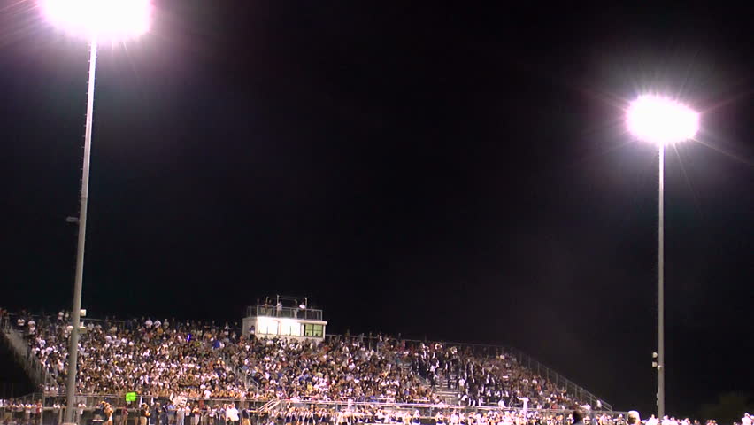 American high school football crowd, overview, lit by stadium lights. 1080p