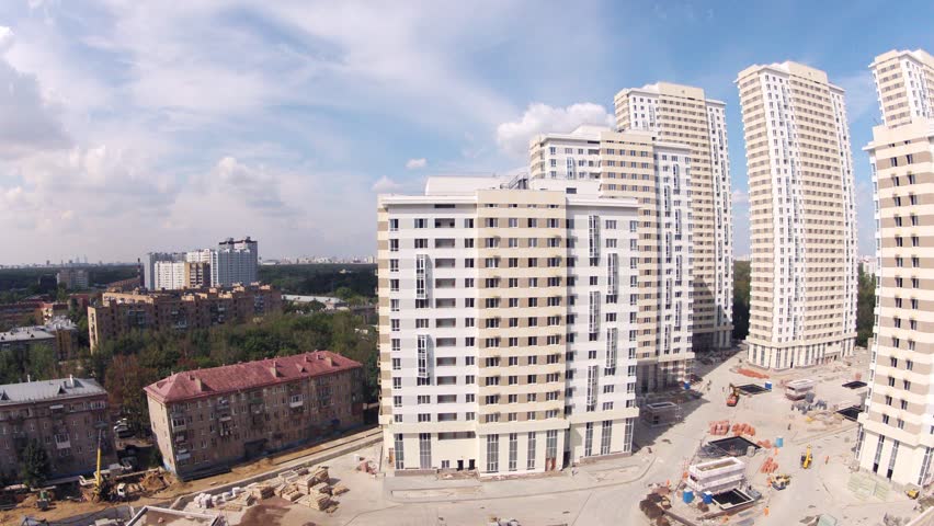 MOSCOW - AUG 6: (Timelapse View) Old five-floor house stands near Housing estate Ekopark Elk Island (Losiniy Ostrov), builder Donstroy, on Aug 6, 2012 in Moscow, Russia