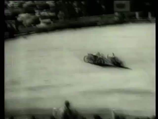 Motorcyclist falls at Daytona 200, a 200-mile motorcycle race, at the Daytona International Speedway in Daytona Beach, FL circa 1958-MGM PICTURES, UNIVERSAL-INTERNATIONAL NEWSREEL, USA, filmed in 1958