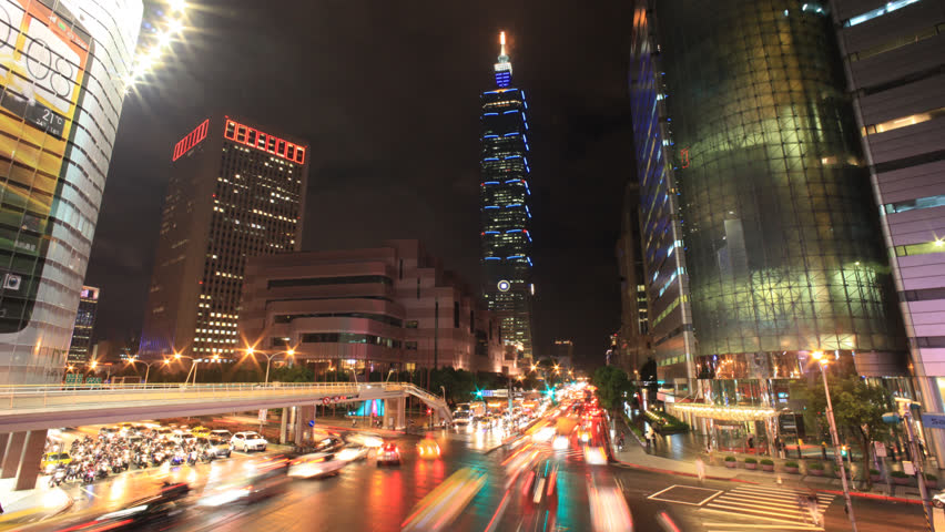 TAIPEI, TAIWAN - CIRCA OCTOBER 2012: (Timelapse View) By the corner of busy Taipei street after working hours with Taipei 101 at back, circa October 2012 in Taipei, Taiwan.
