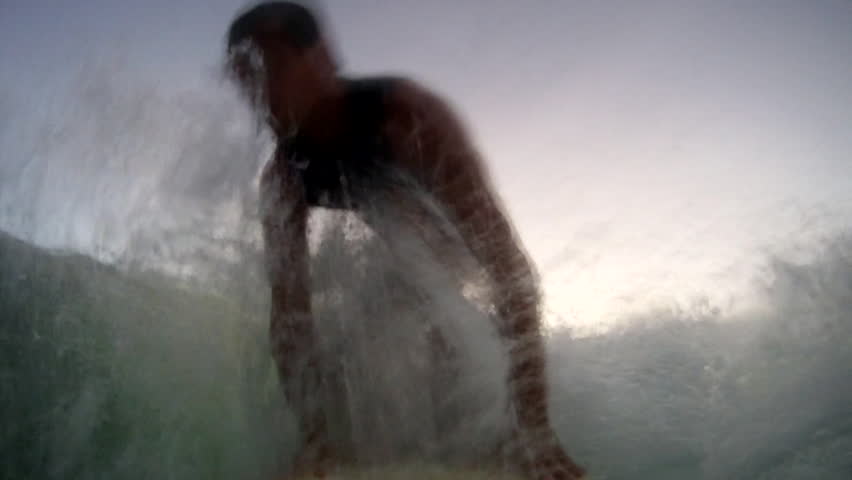 Huge Wave Splashing on the Body of a Man Surfing