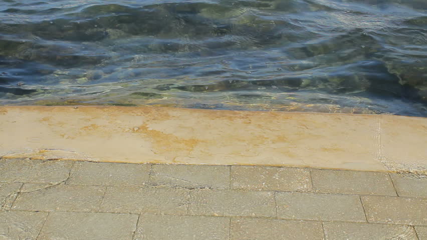 Water coming over dike during extreme high tide