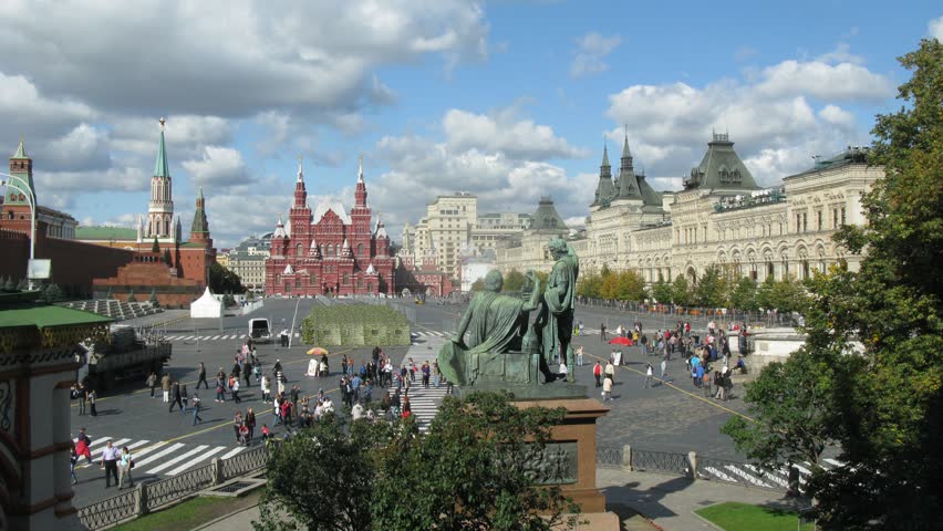 People walk across Red Square near GUM in sunny day, time lapse