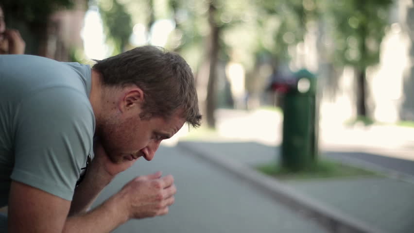 Sad, depressed young man in the city, stabilized shot