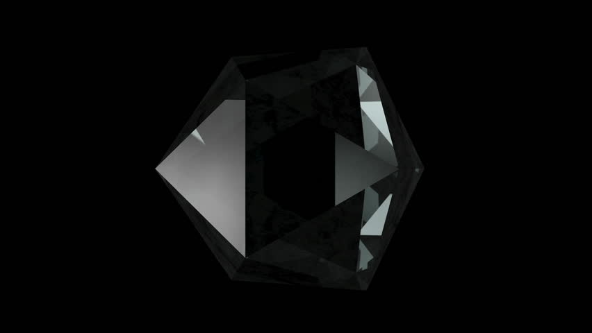 A clear and diamond-like prism rotates on itself in front of a black background. Loops perfectly. Computer generated images.