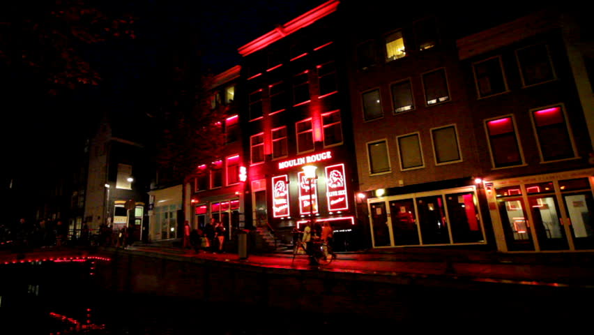 AMSTERDAM - OCTOBER 21: The Red-light district in Amsterdam, The Netherlands on October 21, 2012. The district has acquired a touristic interest beyond sex tourism, thus can be perceived as a place of artistic, historic and cultural interest.